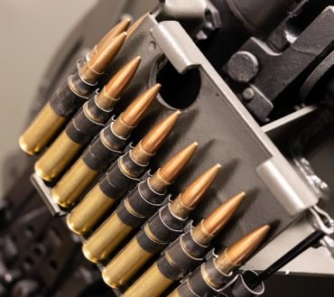 Close up of of bullets in a coaxial machine gun belt